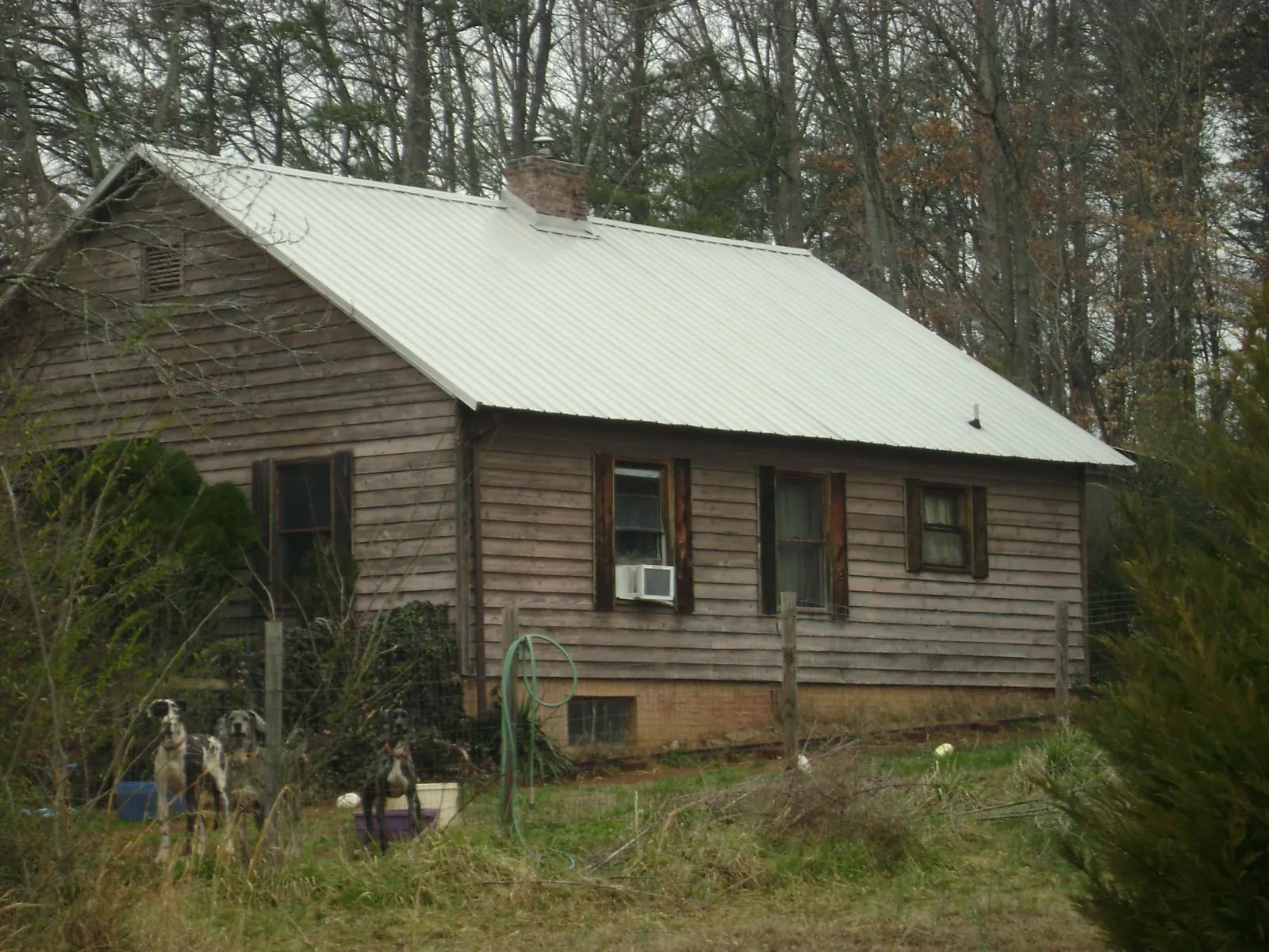 White metal roof on an old wood sided farmhouse, from a Metal Roof Installation job in New Paris